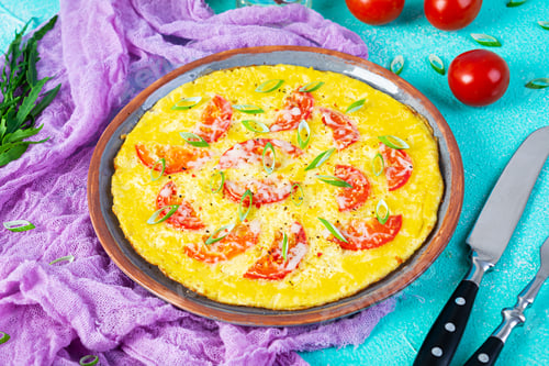 Preview: Omelette with tomatoes, herbs and grated cheese. Easy breakfast