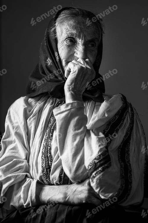 Preview: Thoughtful Senior Woman with Traditional Headscarf