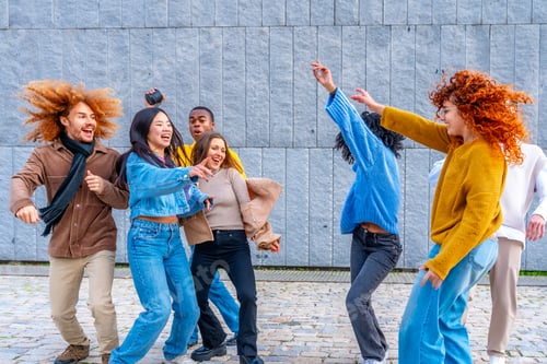 Preview: Multi-ethnic friends dancing excited in the city together