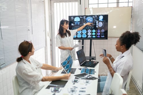 Preview: Team of doctors discuss results of X-Ray or MRI scan of patient's brain in medicine office of clinic