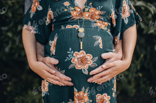 Preview: Young woman and man holding her pregnant belly