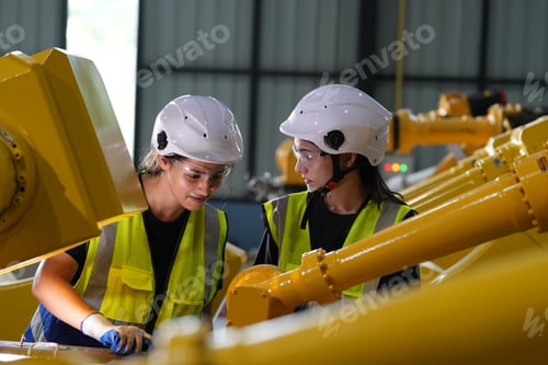 Preview: Robotics engineer working on maintenance of robotic arm in factory warehouse. Business technology.