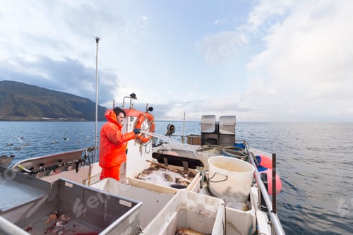 Preview: Fisherman hosing down fishing boat