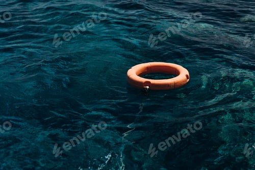 Preview: Orange lifebuoy in the blue sea. Lifebuoy - a way to escape