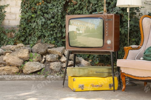 Preview: Retro TV on stand, suitcases and other used stuff outdoors