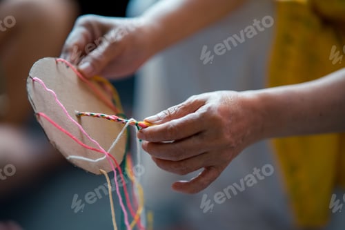 Preview: Hands making bracelets using cardboard