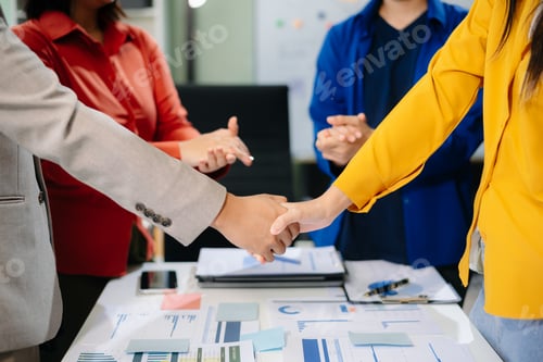 Preview: Business partnership handshake concept.Photo two coworkers handshaking process.