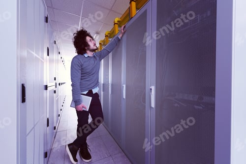 Preview: IT engineer working on a tablet computer in server room