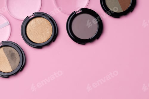 Preview: Set of eyeshadows make up products on pink