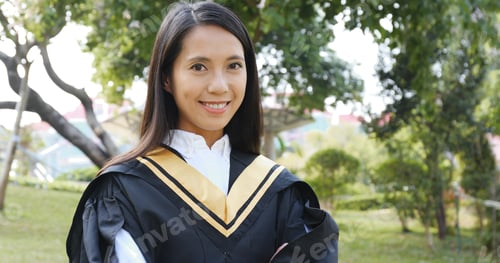Preview: Young woman with graduation gown