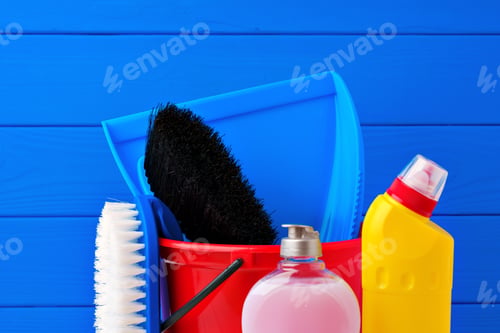 Preview: Various cleaning items against blue wooden background