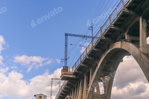 Preview: bridge on a background of white clouds in a blue sky