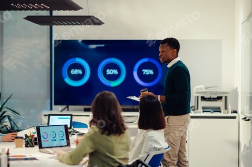 Preview: African american businessman team leader standing in a boardroom and talking