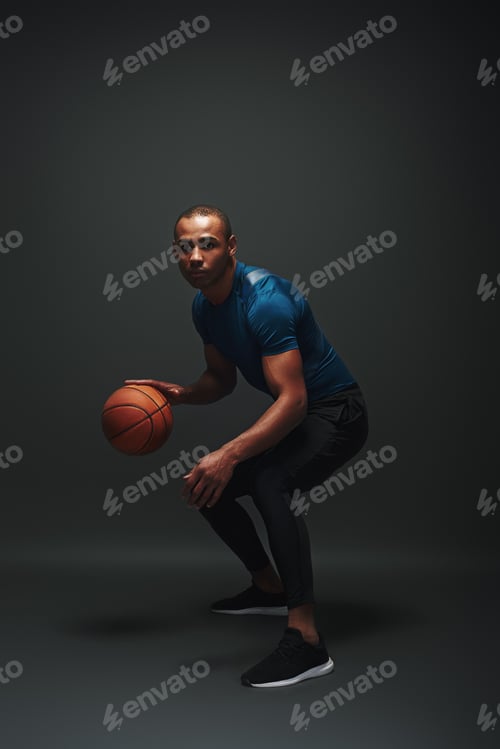 Preview: Nothing but success. Young basketball player standing over dark background