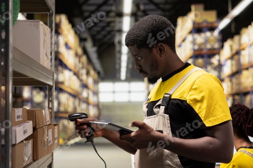 Preview: Black staff member using a barcode scanner to process shipping labels on boxes