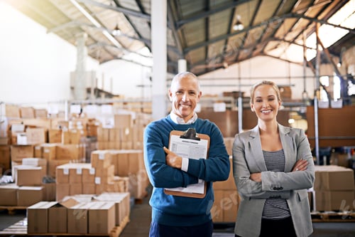 Preview: Portrait of two mangers standing in a large warehouse