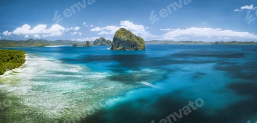 Preview: El Nido, Palawan, Philippines. Panoramic aerial view lonely tourist boat in open sea with exotic