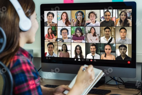 Preview: Rear view of Asian businesswoman working and online meeting via video conference with colleague