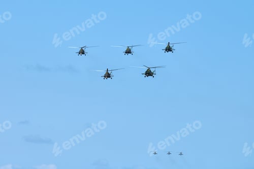 Preview: Military helicopters flying in blue sky performing demonstration flight, aerobatic team, air show