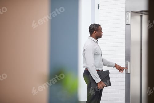 Preview: African-American Businessman Pushing Elevator Button