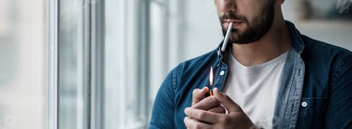 Preview: Young man with cigarette in hand feeling lonely and depressed. Addiction to nicotine