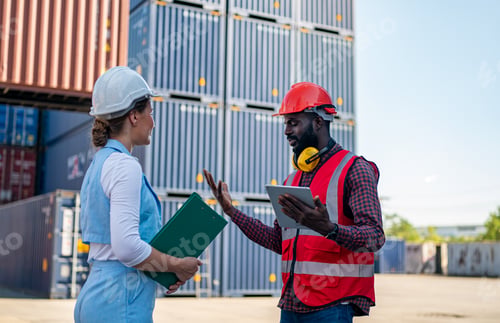 Preview: Foreman control loading Containers box from Cargo freight ship for import export.
