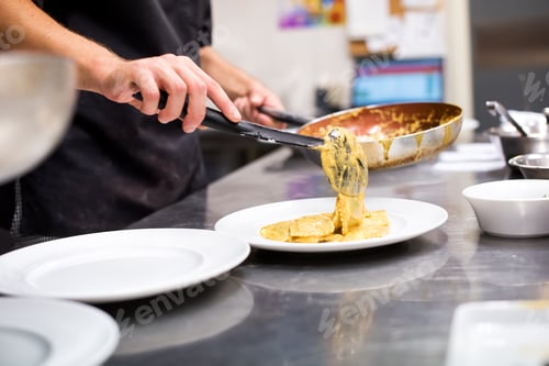 Preview: Chef serving Italian pasta in a restaurant kitchen