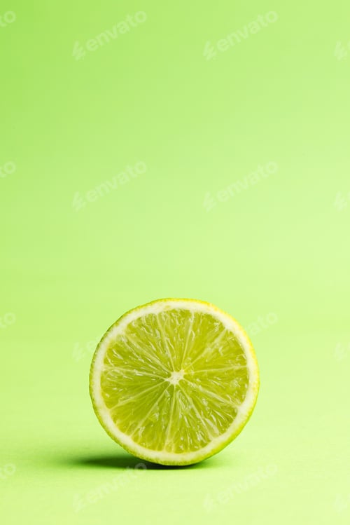 Preview: Close up of halved lime and copy space on green background