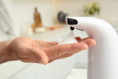 Preview: Man using automatic soap dispenser in kitchen, closeup
