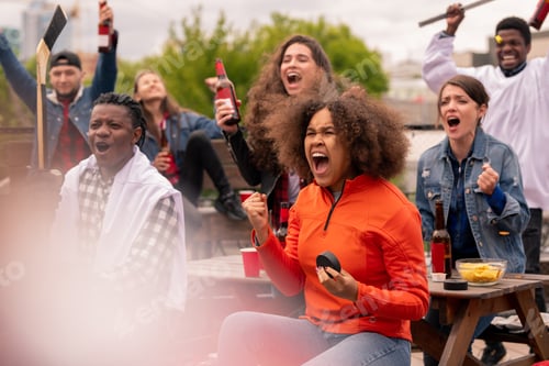 Preview: Young ecstatic hockey fans watching broadcast of world championship outdoors