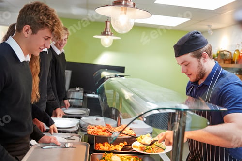 Preview: Teenage Students Being Served Meal In School Canteen