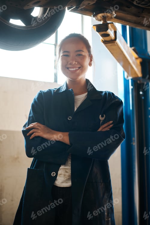 Preview: Shot of a female mechanic posing with her arms crossed in an auto repair shop