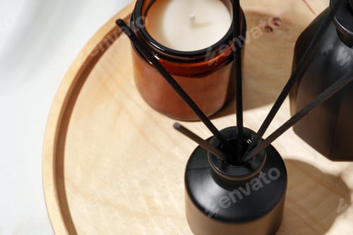 Preview: Black Reed Diffuser, Amber Candle, and Wooden Tray on White Surface