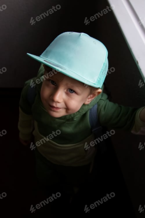 Preview: Boy in blue cap mockup friendly design looking at camera