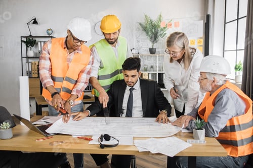 Preview: Group of five multiracial people in suits and helmets brainstorming for common project of building.