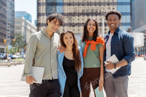 Preview: Group of young professionals smiling together outdoors in the city