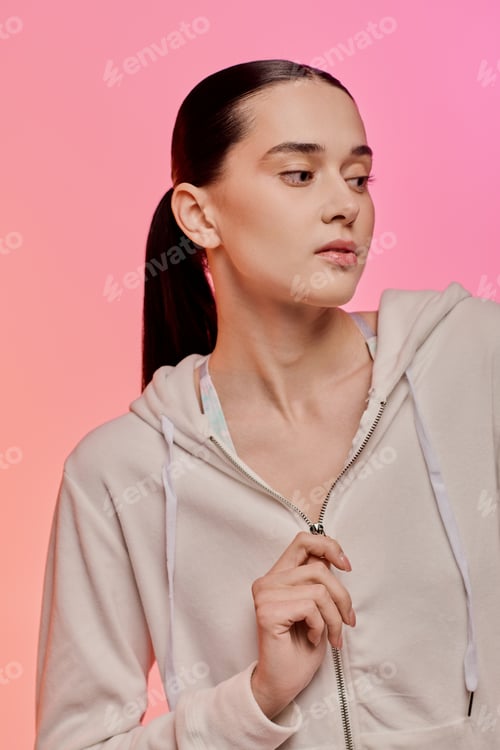 Preview: Stylish beautiful woman exuding confidence with a chic hoodie against a vibrant background