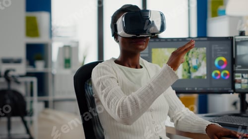 Preview: Black videographer wearing VR headset editing project