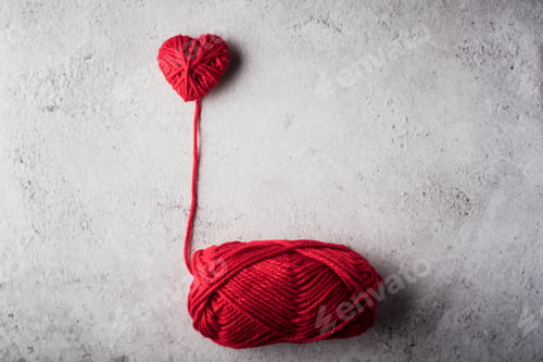 Preview: Red yarn heart shaped on the wall background