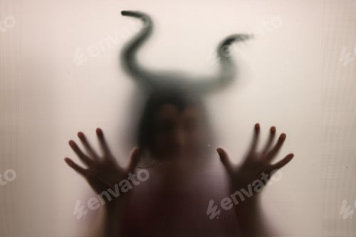 Preview: Horror, halloween background - Shadowy figure with horns behind the glass