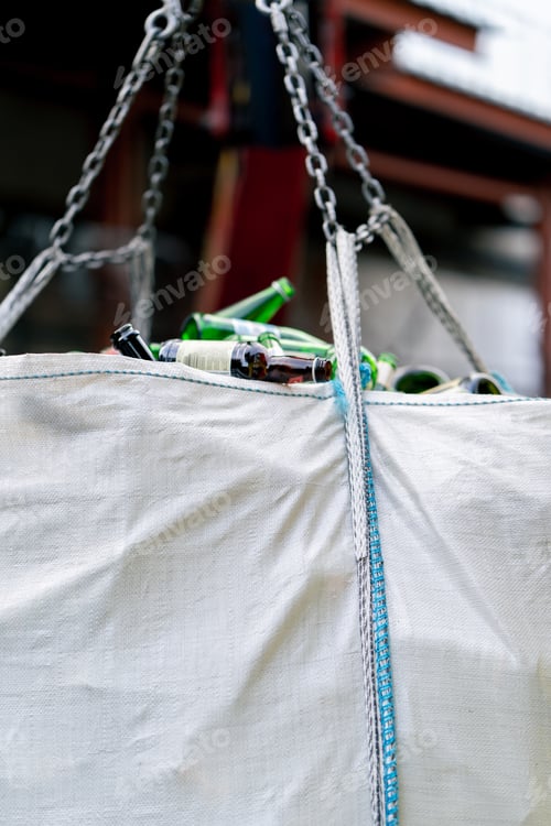 Preview: A forklift lifts a large bag filled with huge amount of empty used glass bottles to transport