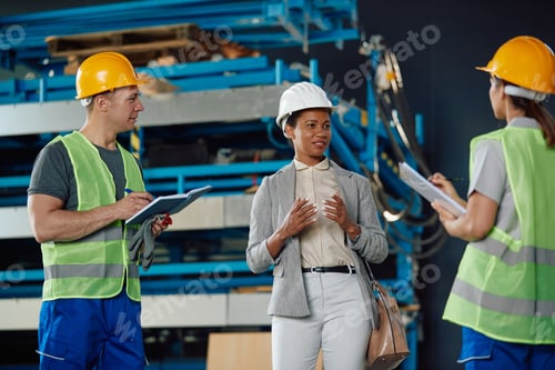 Preview: Black warehouse supervisor communicating with workers during a meeting at storage compartment.
