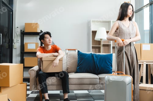 Preview: Unhappy young couple sitting apart, having problems in relationship