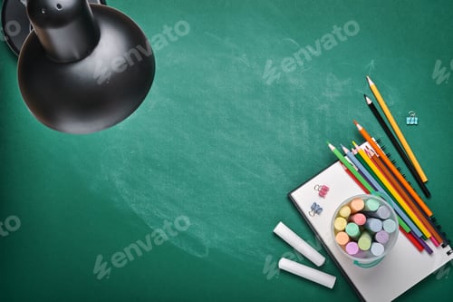 Preview: School supplies and black table lamp on green board. Concept back to school. Mock up for design. Cop