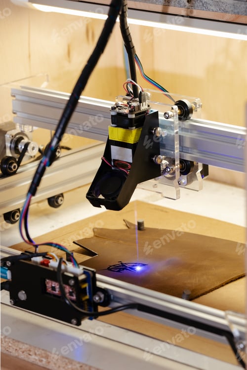 Preview: Laser burning on eco leather. Cropped view of laser machine burning on leather