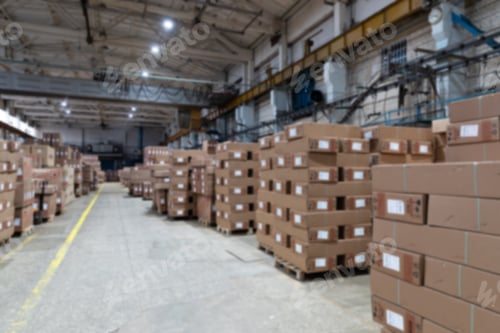 Preview: large warehouse of finished products, cardboard boxes on pallets, blurred photo