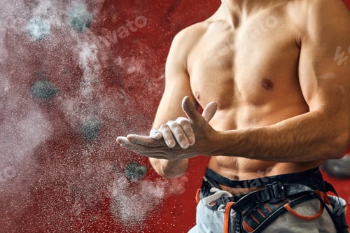 Preview: Climber coating his hands in powder chalk magnesium to climb indoor, close-up