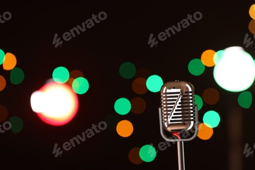 Preview: Vintage microphone on dark background with blurred lights, space for text. Musical equipment