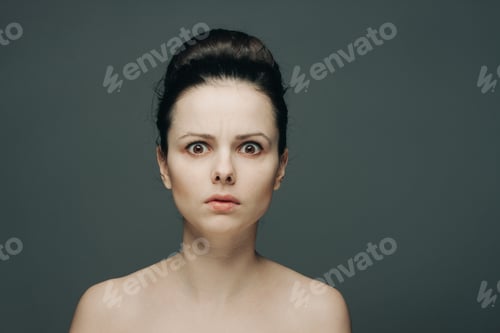 Preview: brunette with bare shoulders surprised look emotions clear skin