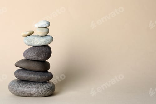 Preview: Stack of stones on beige background, space for text. Harmony and balance concept